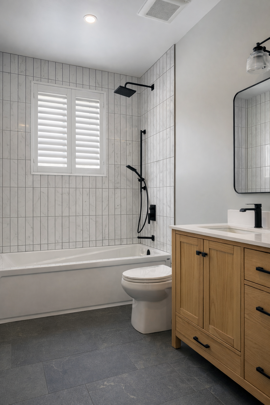 Bathroom renovation with wood vanity and bathtub
