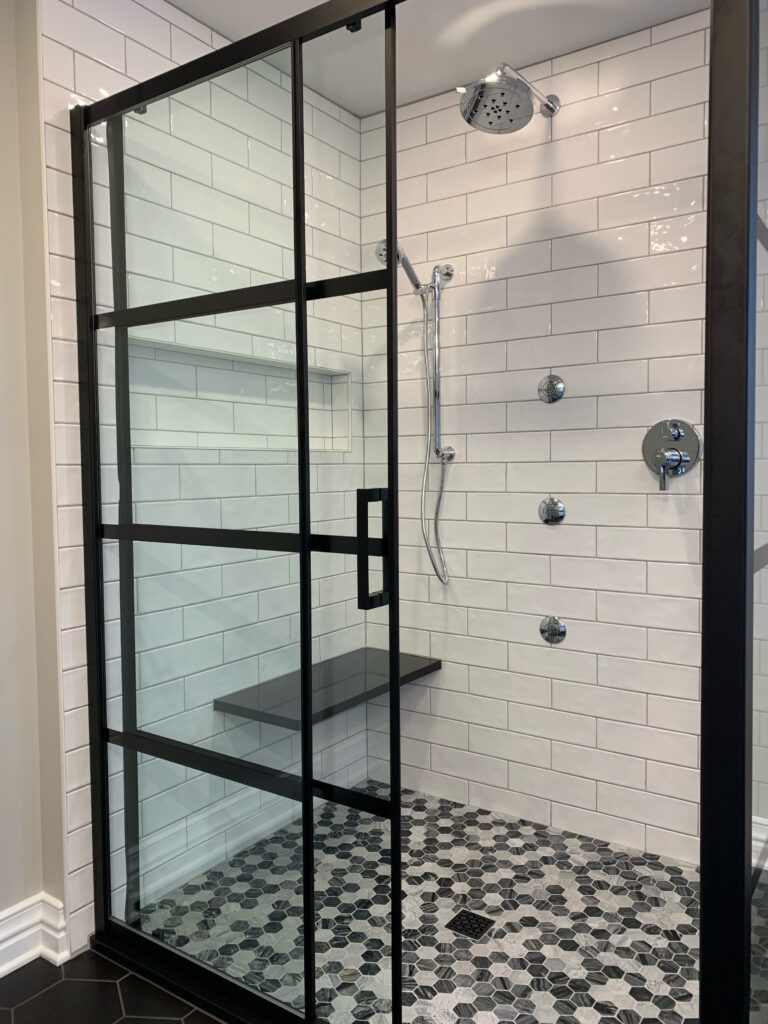 Black framed shower with white subway tile
