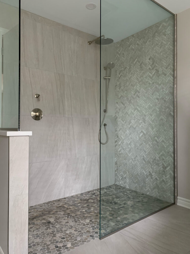 Walk-in shower with pebble tile floor