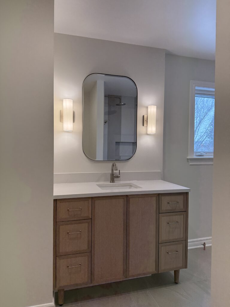 Wood vanity with arched mirror
